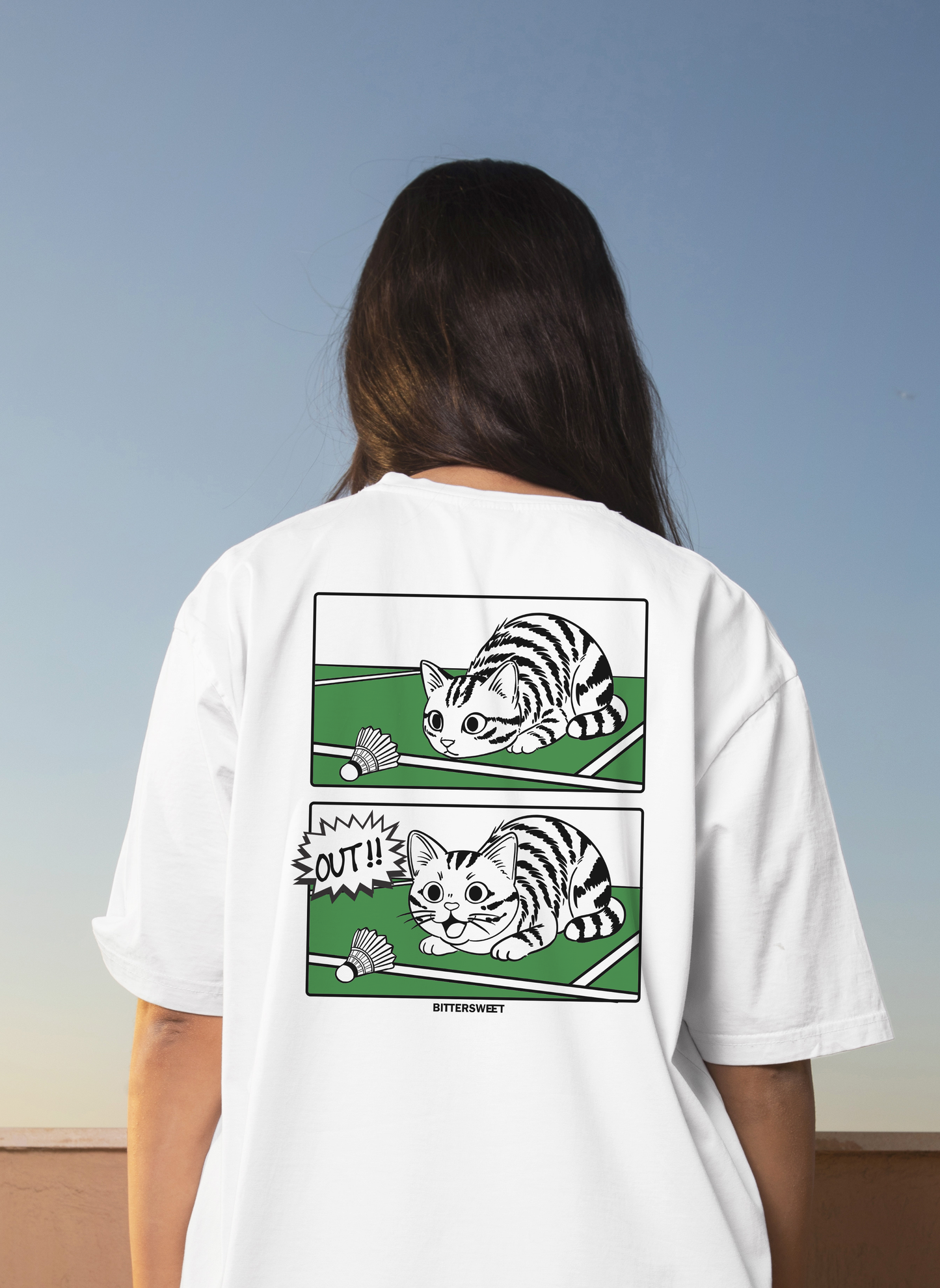 Model wearing badminton cat graphic streetwear tee – casual sport t-shirt by Bittersweet Illustration