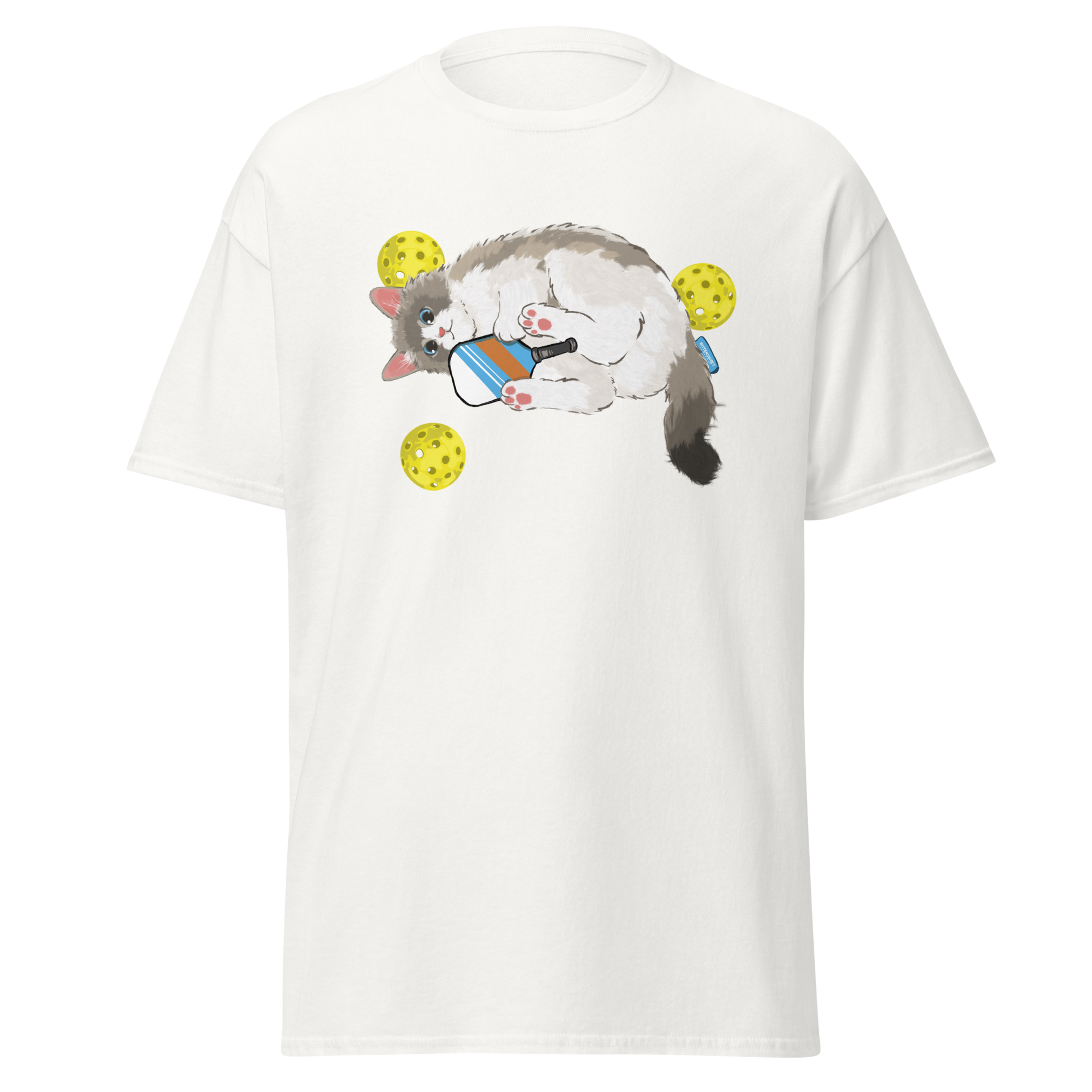White cat pickleball graphic tee on table, cute sport cat printed shirt for pickleball lovers