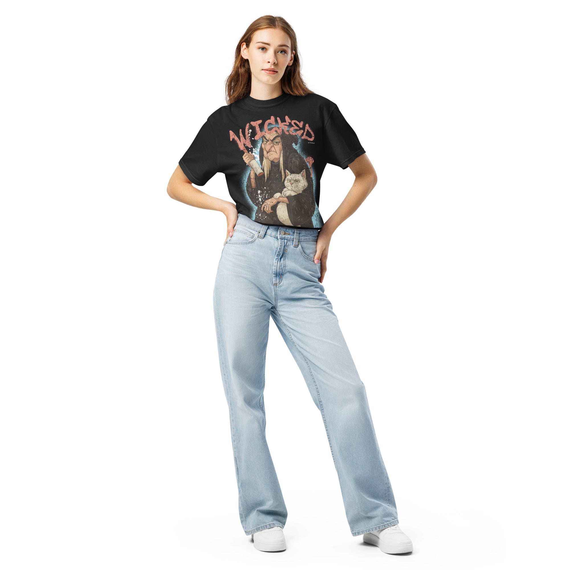 Person wearing a black halloween t-shirt with colorful text and light blue jeans on a white background
